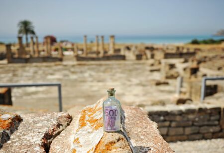 The money power, Five hundred (500) euro bill in a bottle in an old Roman city