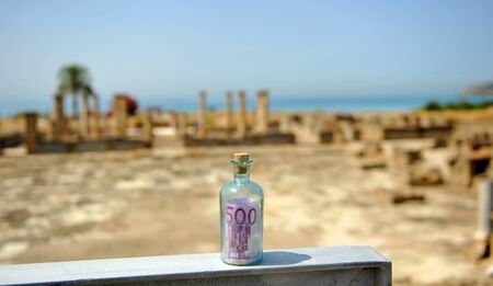 The money power, Five hundred (500) euro bill in a bottle in an old Roman cityの写真素材