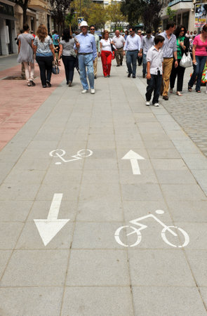 People walking along the bike lane in Los Remedios neighborhood of Seville, Andalusia, Spainのeditorial素材