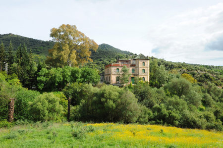 House among trees of the Natural Park of Los Alcornocales. Old residency for engineers and employees of Las Buitreras Hydroelectric Power Plant in El Colmenar, province of Malaga Andalusia Spainのeditorial素材