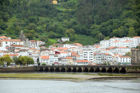 View of a coastal town with a medieval bridgeの写真素材