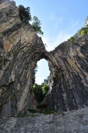 View of a hole in the rock along a pathの写真素材