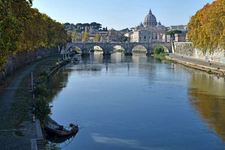 view of the tiber river in autumn with the vatican in the backgroundの写真素材
