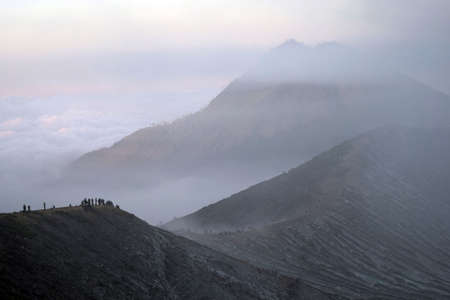 People walking through the ijem volcanoの写真素材