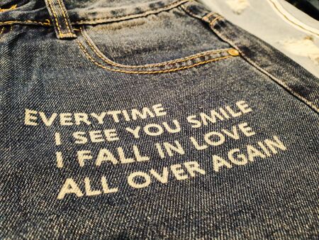 Blue denim jeans printed with closeup romantic love quote and textsの写真素材