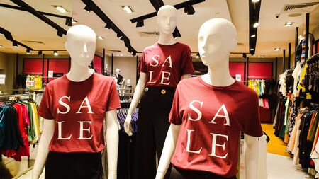 Kuala Lumpur / Malaysia - July 6, 2019: Display of 3 mannequins wearing SALE t shirts with colorful clothing background at Mid Valley Mega Mallのeditorial素材