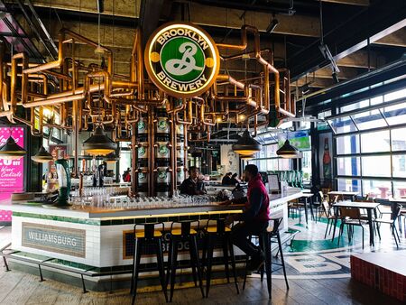 Pahang / Malaysia - July 1, 2019: Customer enjoying drinks and chatting with bar tender at the coolest drinking bar counter in High Line Roof Top Market at Sky Avenue Genting Highlandsのeditorial素材