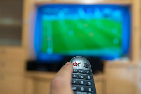 Watching a soccer game on television.の写真素材