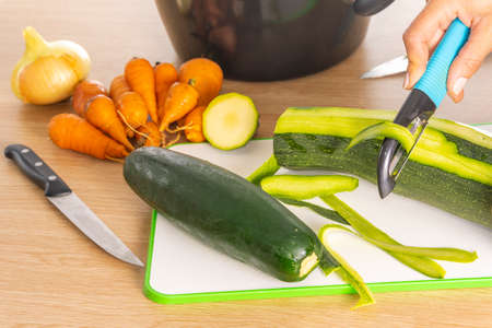 Peeling zucchini.