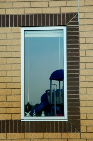 window with park reflection in it の写真素材
