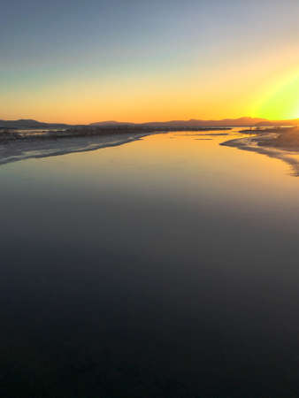 Sunset over a calm river in Iceland during winter