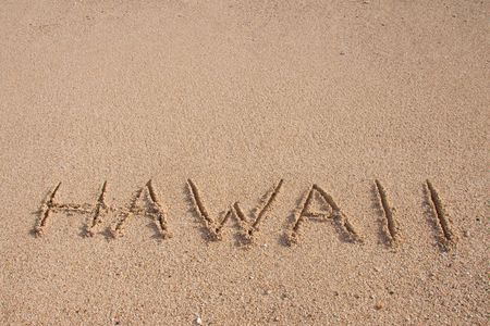 The word HAWAII is written on the beach with room for text or copy space.の写真素材