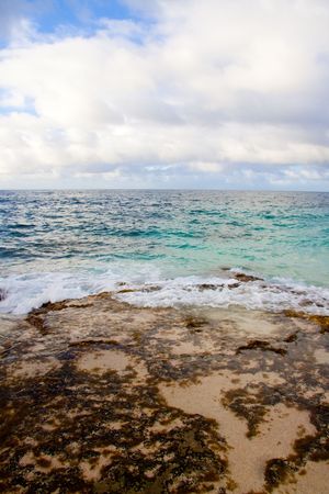 A beautiful beach with nobody in the scene as well as a dynamic sky and nice turquoise and blue tones throughout in color.の写真素材