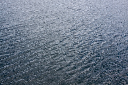 Water in Lake Tahoe is photographed in an abstract way to show the waves, the blue tones, and the...