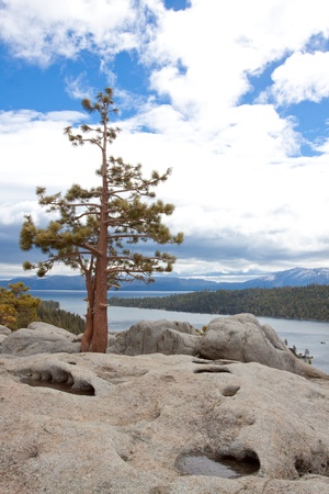 Views of Lake Tahoe in California with crystal clear water, snow on the ground, and mountains in the background.の写真素材
