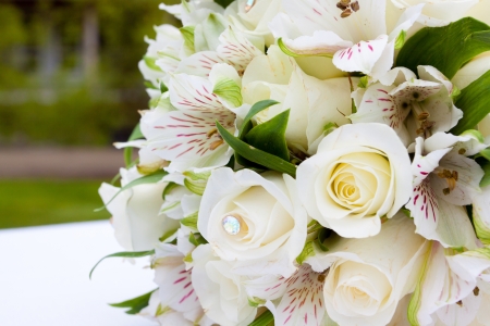A white flower bouquet at a wedding ceremony with jewels in the flowers の写真素材