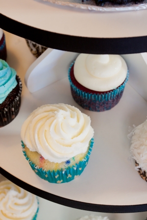 Several cupcakes on a serving table at a wedding ceremony and reception  The colors here are black, blue, and white の写真素材