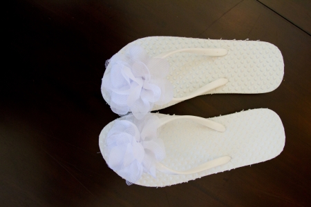 Simple white flip flop sandals for a bride to wear on her wedding day.の写真素材