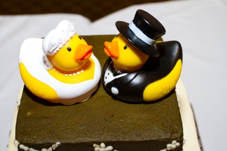 Rubber ducks are the cake toppers for this wedding cake at a very non-traditional reception for the bride and groom.の写真素材