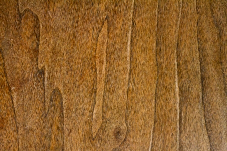 A wood grain background texture detail abstract. The wood color is rich brown in tone and the image is horizontal.の写真素材