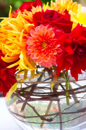 Wedding decor at a ceremony and reception with beautiful red and yellow flowers.の写真素材
