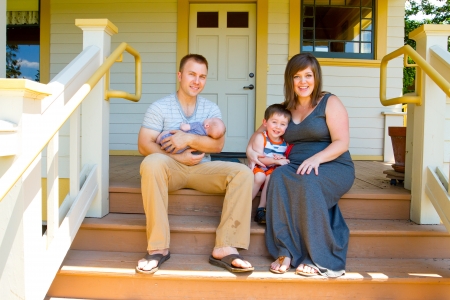This family of four includes a mom, dad, 5 year old son, and a newborn son.の写真素材