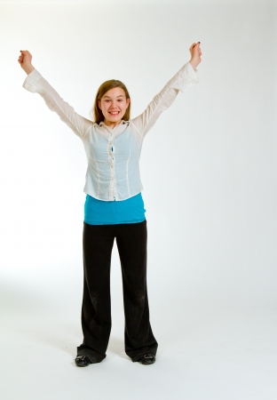 A young girl against a white background in the studio for a simple portrait の写真素材