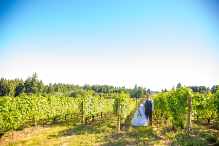 Portraits of a bride and groom outdoors in a vineyard at a winery in Oregon right after their ceremony and vows.の写真素材