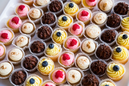 These cupcakes at a wedding reception are ready for the guests to enjoy after the cake cutting...