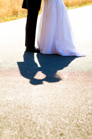 A bride and groom kiss and their shadow is photographed to create a nice visual abstract.の写真素材