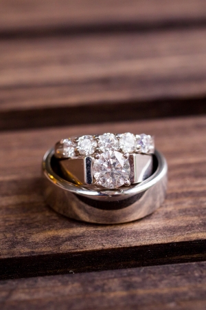 Wedding rings are photographed on a dark wooden box to create this great color closeup image.