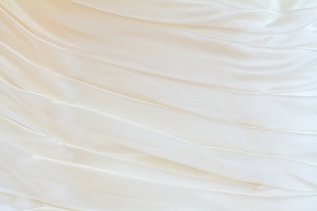 The wedding dress of a bride is photographed to show some of the abstract details of the fashion clothing.の写真素材