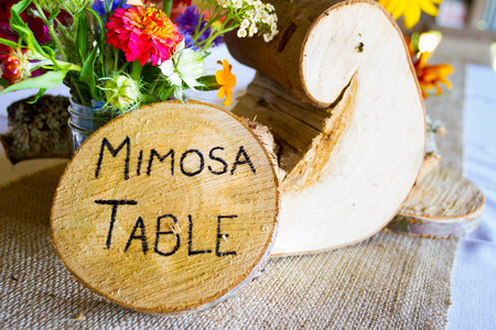 Wedding decor and decorations are made up of wildflowers and crosscut sections of fir trees at this organic natural reception in Oregon.の写真素材