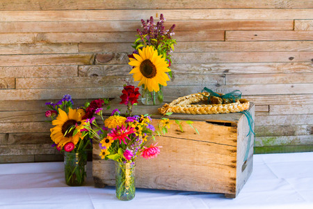Organic natural wildflowers are placed in mason jars to create the wedding decor for this Oregon reception.の写真素材