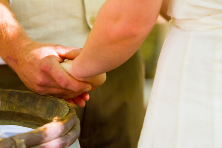 Holding hands during the wedding ceremony this bride and groom share a special moment of touch.