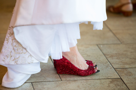 Red shoes worn by the bride on her wedding day.の写真素材