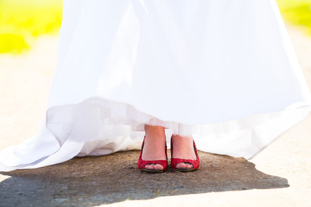 Red shoes worn by the bride on her wedding day.の写真素材