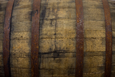 Bourbon barrel at a brewery with aged beer inside.