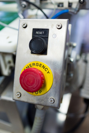 Emergency stop and reset buttons at a brewery looking industrial.