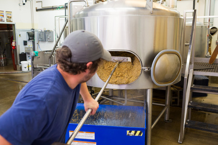 Eugene, OR, USA - July 17, 2014: Brewer at Oakshire Brewing making large quantities of Watershed IPA, a staple beer for this craft brewery.のeditorial素材