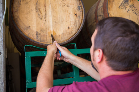 Eugene, OR, USA - July 17, 2014: Master brewer at Oakshire Brewing sampling and tasting bourbon...