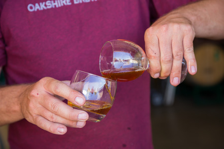 Eugene, OR, USA - July 17, 2014: Bourbon barrel aged beer being sampled and tasted as part of the brewing process for limited releases from Oakshire Brewing.のeditorial素材