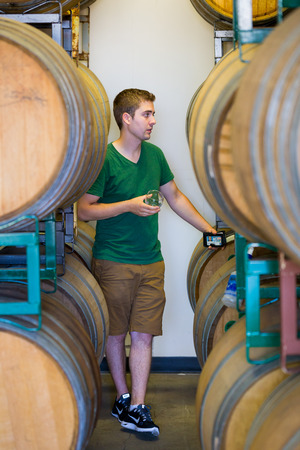 Eugene, OR, USA - July 17, 2014: Master brewer at Oakshire Brewing sampling and tasting bourbon...
