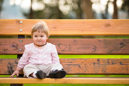 Portrait of a one year old girl at a park with natural light.の写真素材
