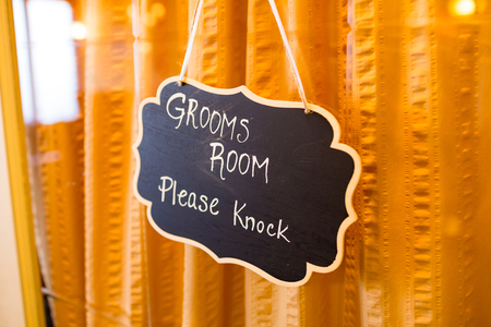 Please knock sign on the getting ready room of the groom on his wedding day.の写真素材