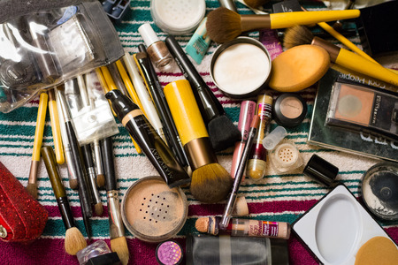 Eugene, OR, USA - March 21, 2015: Makeup brushes and various makeup items on a table during wedding preparation.のeditorial素材