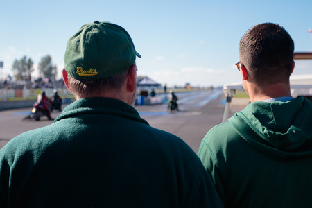 WOODBURN, OR - SEPTEMBER 27, 2015: Spectators watching motorcycle races from behind the starting line at the NHRA 30th Annual Fall Classic at the Woodburn Dragstrip.のeditorial素材