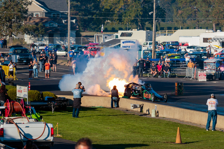 WOODBURN, OR - SEPTEMBER 27, 2015: Darin Bay's Warped Speed Black Rat jet dragster blows fire and smoke towards spectators during the NHRA 30th Annual Fall Classic at the Woodburn Dragstrip.のeditorial素材
