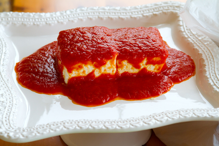 Red sauce cream cheese dip ready for a party.の写真素材