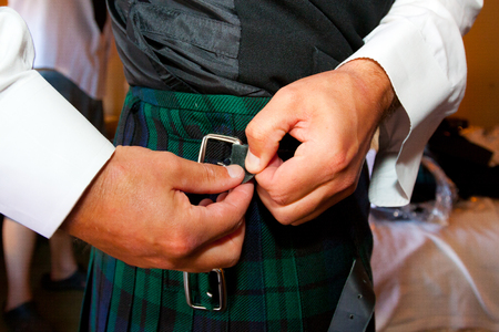 Traditional Scottish wedding day attire of a kilt worn by the groom.の写真素材